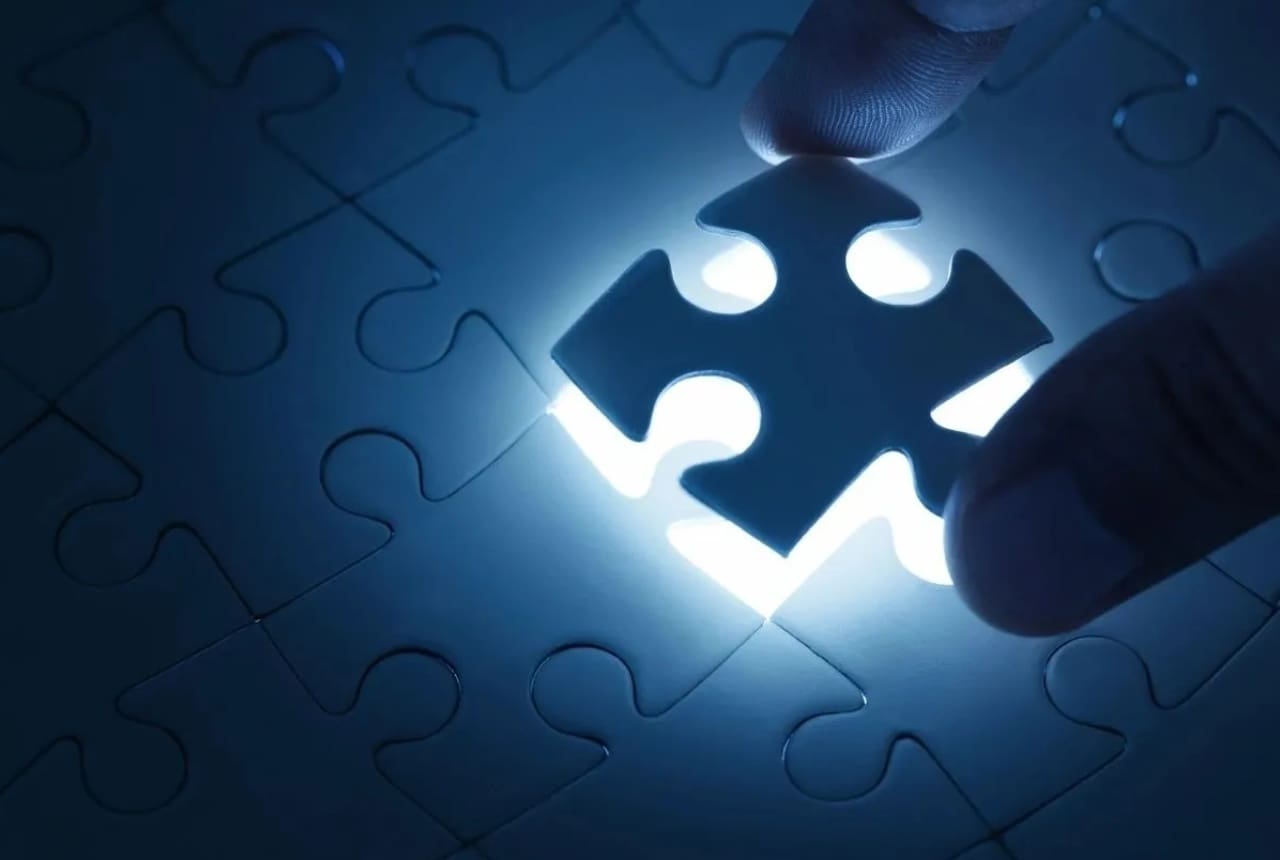 A person is holding the light of a puzzle piece.